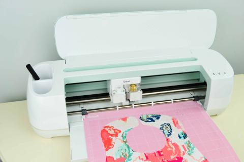 image of a cricut maker machine and pink cutting mat